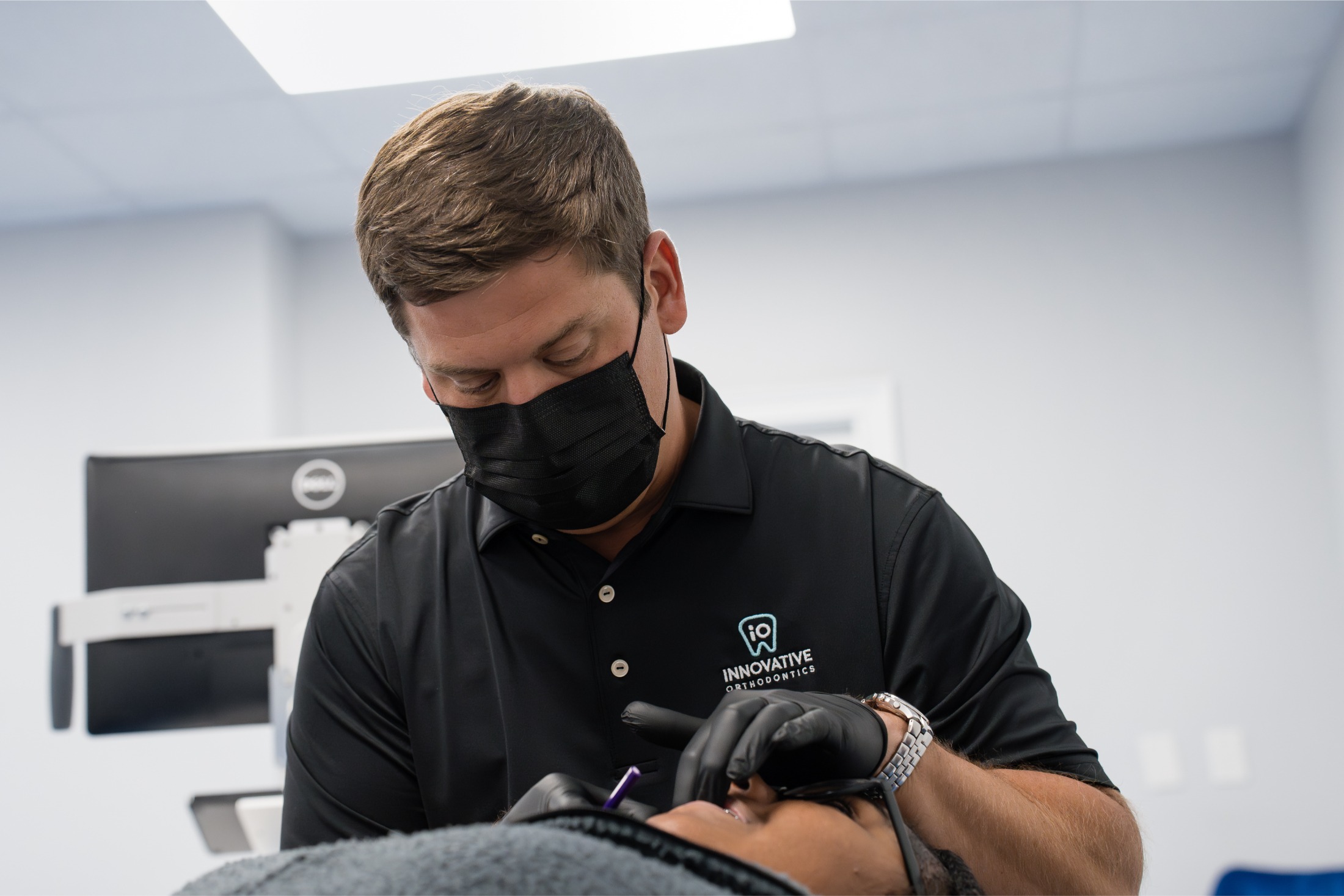 Orthodontist examining child's teeth, Innovative Orthodontics dental care for children.