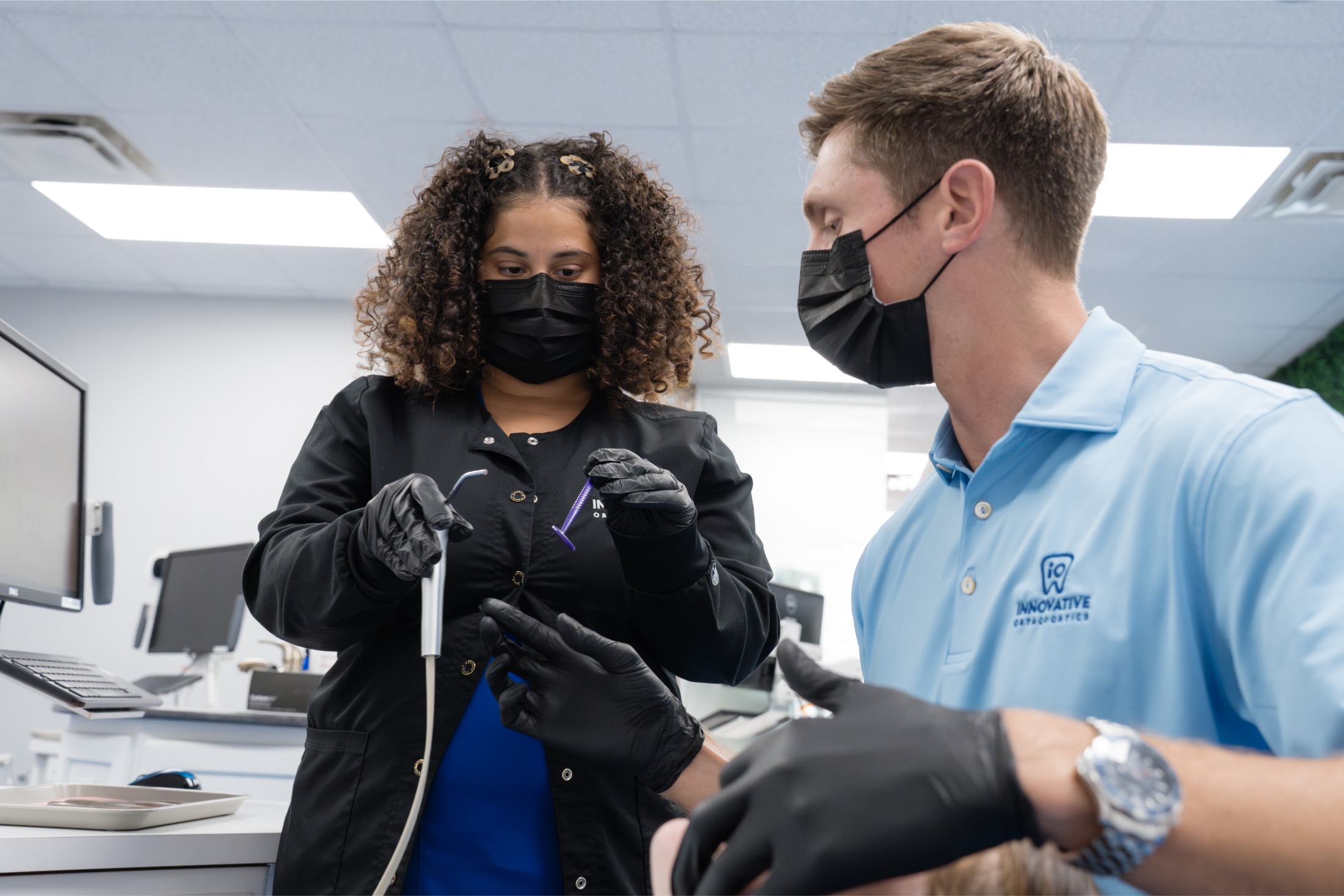 Innovative Orthodontics team member examining patient, personalized orthodontic care.